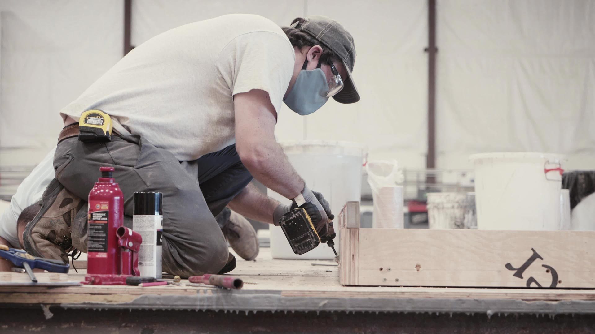 Man drilling; concrete formliners