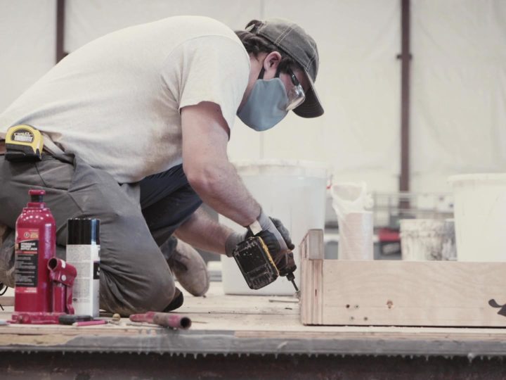 Man drilling; concrete formliners